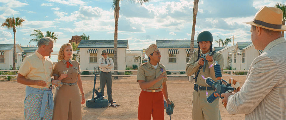 This image released by Focus Features shows Tom Hanks, from left, Hope Davis, Tony Revolori and Liev Schreiber, right, in a scene from "Asteroid City." (Focus Features via AP)