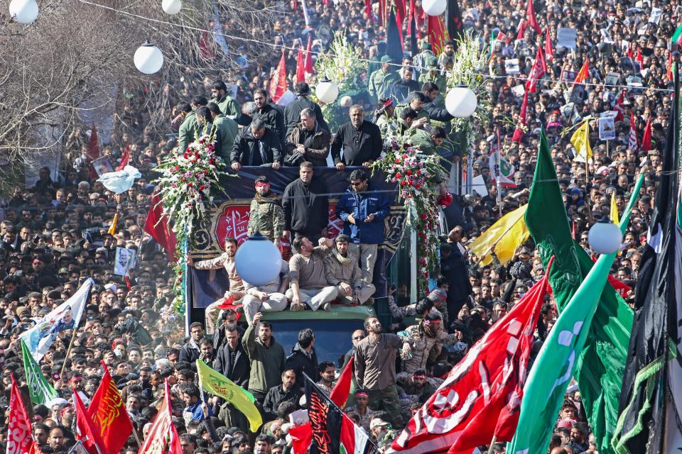 Iranian mourners gather around a vehicle carrying the coffin of slain top general Qasem Soleimani during the final stage of funeral processions, in his hometown Kerman on January 7, 2020. - Soleimani was killed outside Baghdad airport Friday in a drone strike ordered by US President Donald Trump, ratcheting up tensions with arch-enemy Iran which has vowed "severe revenge". The assassination of the 62-year-old heightened international concern about a new war in the volatile, oil-rich Middle East and rattled financial markets. (Photo by ATTA KENARE / AFP) (Photo by ATTA KENARE/AFP via Getty Images)