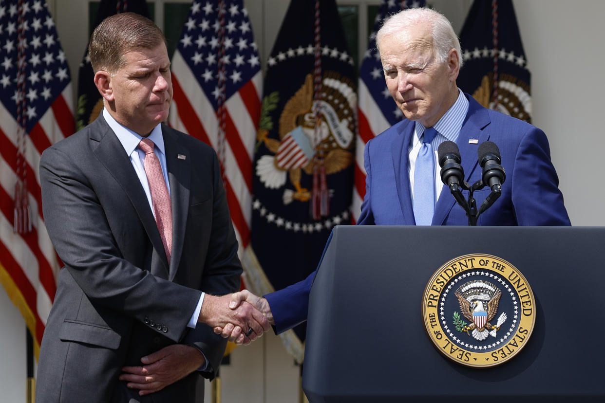 President Biden shakes hands with Labor Secretary Marty Walsh on September 15, 2022 after announcing a tentative labor agreement to avert a nationwide rail strike. (Photo by Anna Moneymaker/Getty Images)