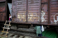 <p>Children peer from a carriage at a train station turned into a makeshift camp crowded by migrants and refugees, at the northern Greek border point of Idomeni, Greece, April 29, 2016. Many thousands of migrants remain at the Greek border with Macedonia, hoping that the border crossing will reopen, allowing them to move north into central Europe. <i>(Gregorio Borgia/AP)</i></p>