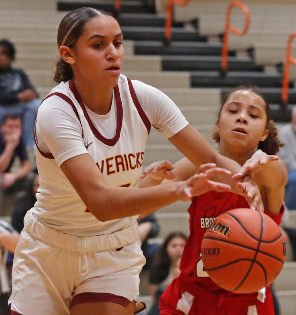 McCutcheon Mavericks Lillie Graves (12) and Lafayette Jeff Bronchos Shaylee Barrett (20) fight for a rebound during the IU Health Hoops Classic girl’s basketball seventh place game, Saturday, Nov. 18, 2023, at Harrison High School in West Lafayette, Ind. McCutcheon Mavericks won 62-32.