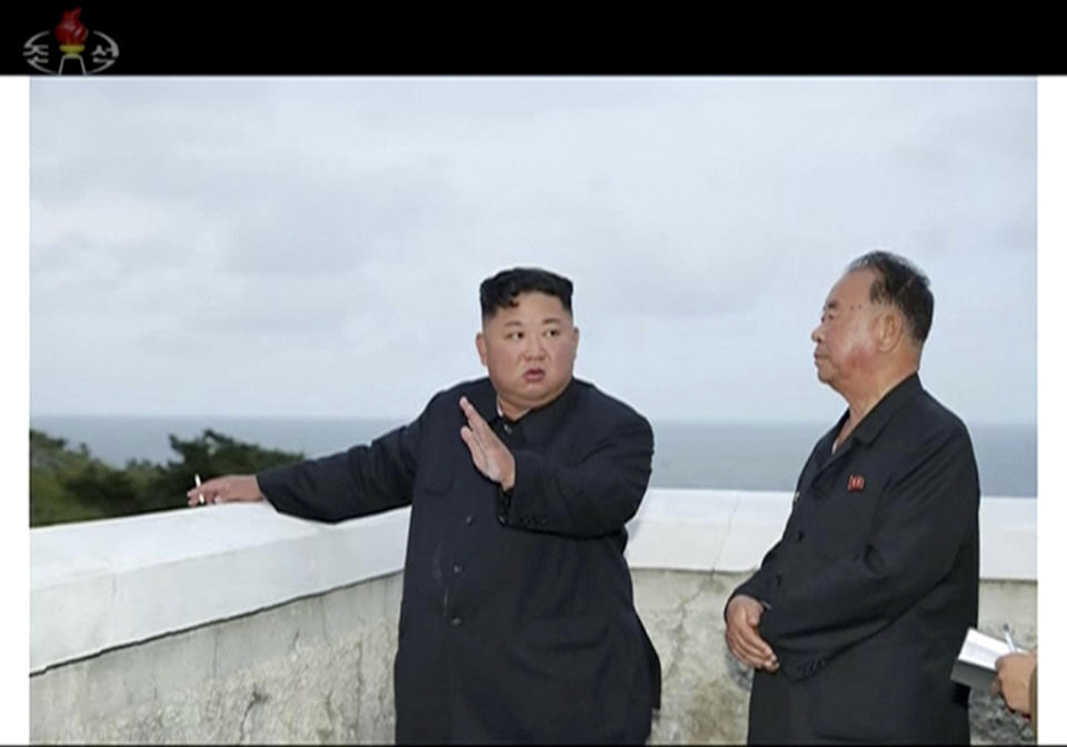 In this image made from video of a still image broadcasted by North Korea's KRT on Sunday, Aug. 11, 2019, North Korean leader Kim Jong Un, left, watches test firings of an unspecified new weapons system at an undisclosed location in North Korea. North Korea said Sunday leader Kim supervised the test-firings, which extended a streak of launches that are seen as an attempt to build leverage ahead of negotiations with the United States while driving a wedge between Washington and Seoul.(KRT via AP Video)