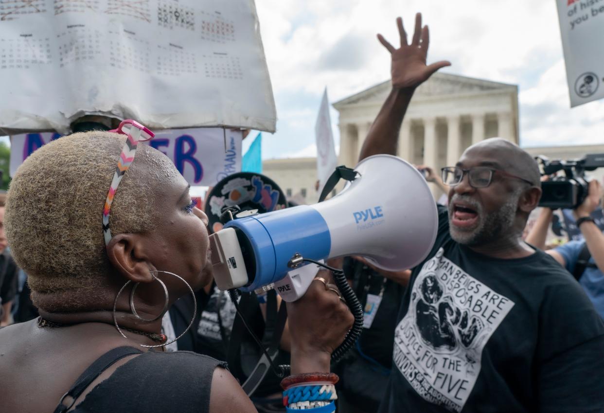 An abortion-rights protester, and an anti-abortion protester face off ahead of the Supreme Court decision to overturn Roe v. Wade in Washington on Friday.