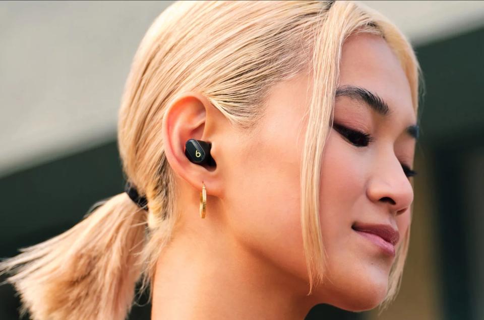 a model wearing the earbuds in black