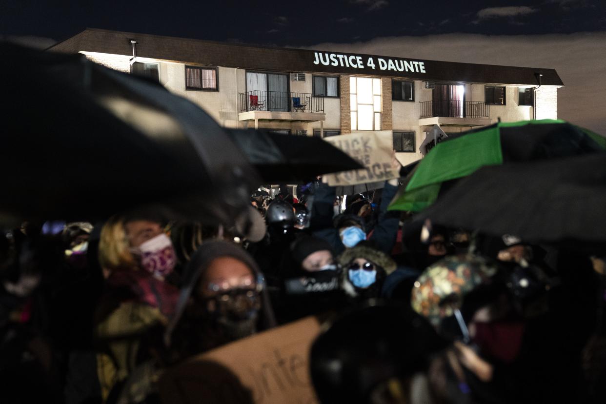 "Justice 4 Daunte" is projected onto a residence as people take part in a protest near the Brooklyn Center Police Department on Thursday in Brooklyn Center, Minn.