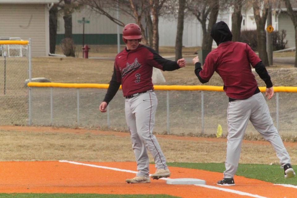 Carter Tetrault (left) reaches first base against May-Port-C-G on April 9.