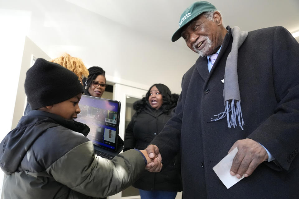 Danny Davis, right, who is the U.S. representative from Illinois's 7th congressional district, greets Miles Durosinmi, 7, after voting at Sankofa Cultural Arts & Business center in Chicago, Tuesday, March 19, 2024. Illinois residents will vote Tuesday to narrow Democratic and GOP candidate fields in key U.S. House races. (AP Photo/Nam Y. Huh)