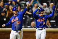 New York Mets' Pete Alonso (20) and Brandon Nimmo (9) gesture to Eduardo Escobar after they scored on a two-run single by Escobar during the eighth inning of a baseball game against the Miami Marlins Wednesday, Sept. 28, 2022, in New York. (AP Photo/Frank Franklin II)