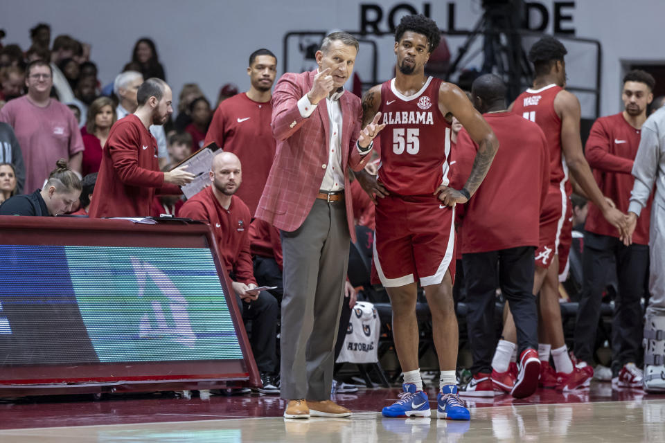 Alabama head coach Nate Oats works with guard Aaron Estrada (55) during the first half of an NCAA college basketball game against Arkansas, Saturday, March 9, 2024, in Tuscaloosa, Ala. (AP Photo/Vasha Hunt)