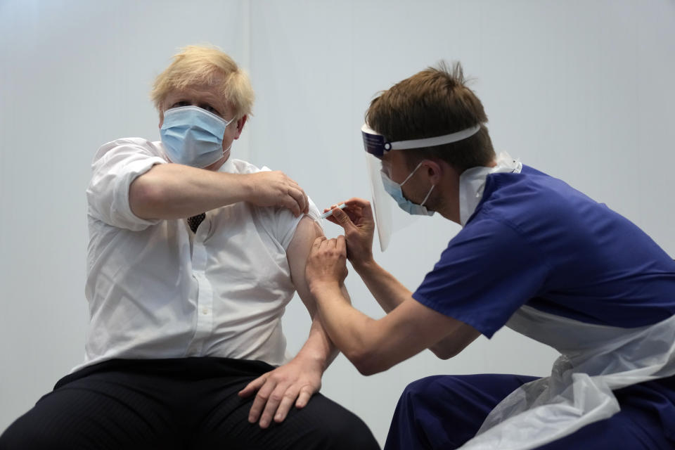 British Prime Minister Boris Johnson receives his second jab of the AstraZeneca coronavirus vaccine from James Black, at the Francis Crick Institute in London, Thursday, June 3, 2021. (AP Photo/Matt Dunham, Pool)