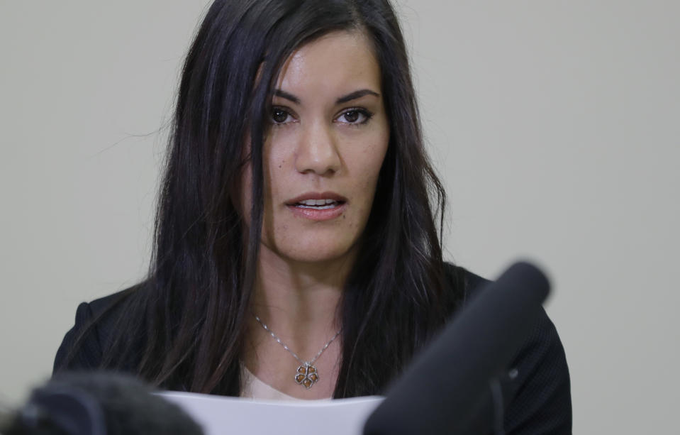 Cora Weberg, a nurse arrested in connection with a possible outbreak of hepatitis C at a hospital in Puyallup, Wash., reads a prepared statement on May 8 in Fircrest, Wash. Weberg said she didn’t use drugs and is not a carrier of hepatitis C. (Ted S. Warren/AP)