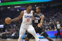 Los Angeles Clippers guard Paul George (13) is guarded by Sacramento Kings forward KZ Okpala (30) during the first quarter of an NBA basketball game in Sacramento, Calif., Saturday, Oct. 22, 2022. (AP Photo/Randall Benton)