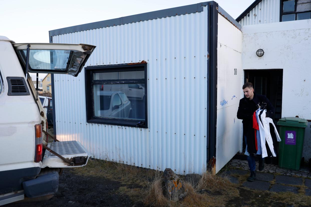 A resident from the town of Grindavik, Iceland, takes some of their belongings from their house (AP)