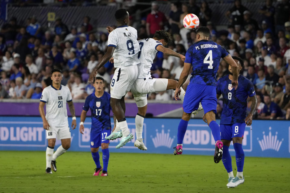 El Salvador forward Bryan Gil (9) and midfielder Enrico Duenas, center go up for a head against United States defender Miles Robinson (4) during the first half of a CONCACAF Nations League soccer match Monday, March 27, 2023, in Orlando, Fla. (AP Photo/John Raoux)