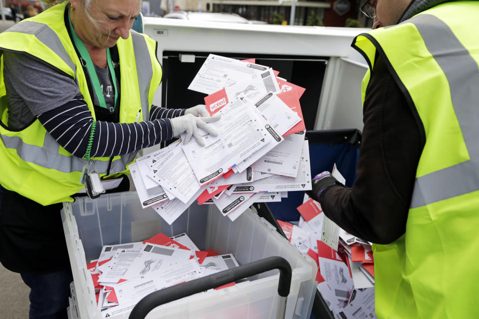 King County Election workers collect ballots from a dropbox in the Washington state primary on March 10, 2020, in Seattle. Washington is a vote-by-mail state.&nbsp; (Photo: AP Photo/John Froschauer)