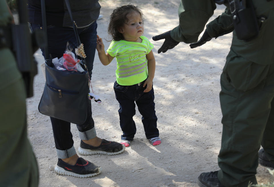 U.S. Border Patrol agents take a Central American family into custody on June 12, 2018 near McAllen, Texas.