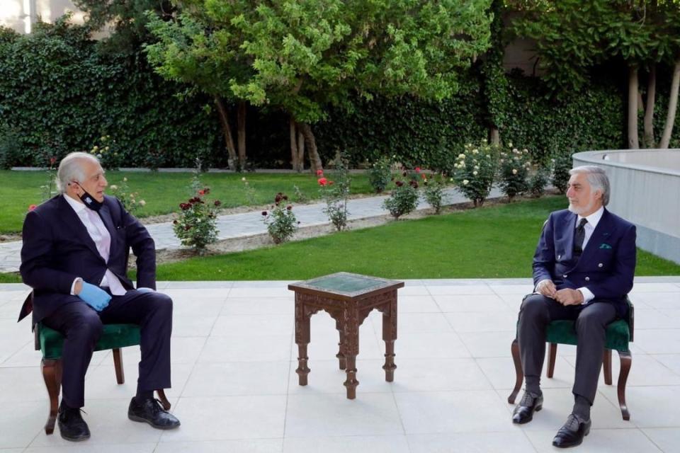 In this Wednesday, May 20, 2020 photo, Abdullah Abdullah, right, President Ashraf Ghani's fellow leader under a recently signed power-sharing agreement, holds a meeting with U.S. peace envoy Zalmay Khalilzad aimed at resuscitating a U.S.-Taliban peace deal signed in February, at the presidential palace, in Kabul, Afghanistan. (Sapidar Palace via AP)