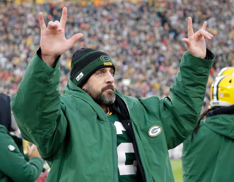 Aaron Rodgers acknowledges the fans at Lambeau Field as they cheer after the quarterback broke the Packers' all-time passing touchdowns record.