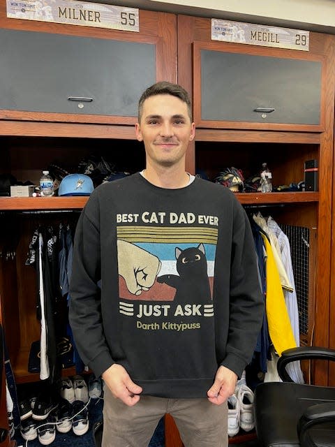 Brewers pitcher Hoby Milner shows off the shirt honoring his family's pet cat.