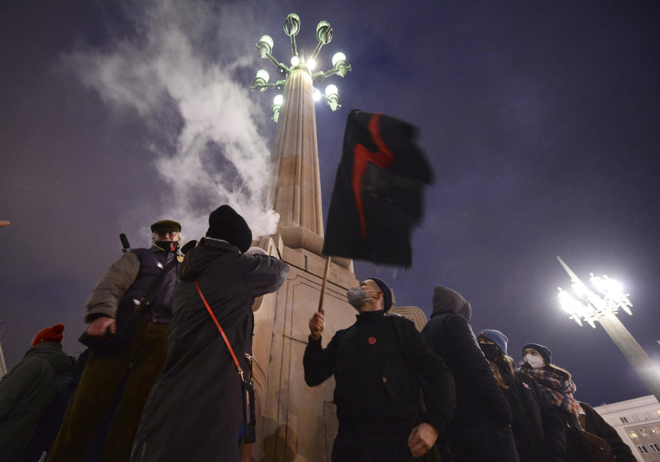 People demonstrate against police violence and an attempted restriction on abortion rights in Warsaw Poland, Saturday, Nov. 28, 2020. Nationwide protests Saturday were scheduled to coincide with Polish women gaining the right to vote 102 years ago. Weeks of protests against a high court's ruling to further restrict Abortion rights have evolved into the largest protest movement since communism fell 30 years ago.(AP Photo/Czarek Sokolowski)