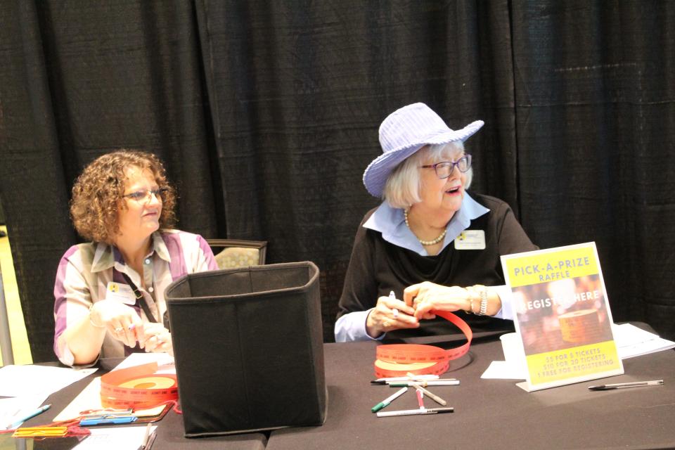 Southport-Oak Island Area Chamber of Commerce volunteer Ann Hollingsworth (right) helping at registration at the Coastal Consumer Showcase in 2023.