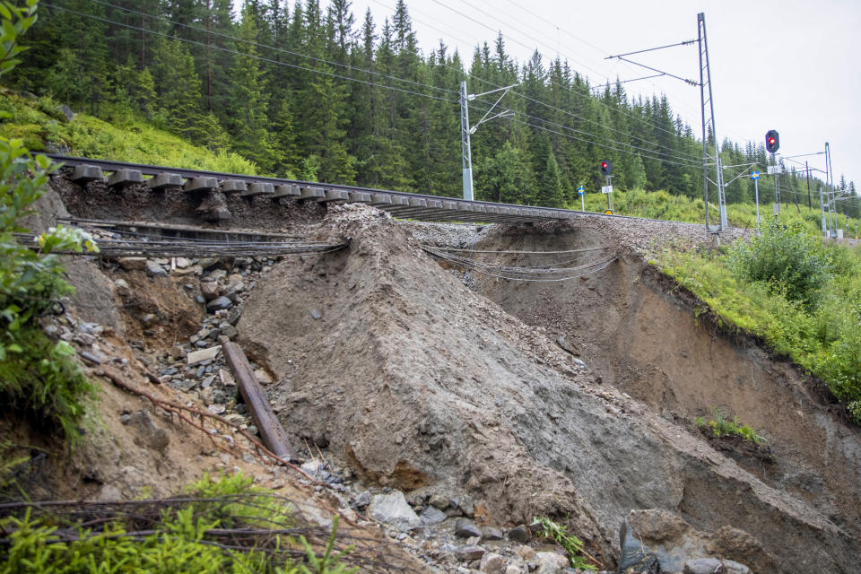 Collapsed parts of the Bergen Trainline due to the extreme weather are seen in Hole, Norway, Wednesday Aug. 9, 2023. Landslides were reported overnight across mountainous southern Norway with police on Wednesday saying more than 600 people have been evacuated in the region north of Oslo. (Frederik Ringnes/NTB Scanpix via AP)