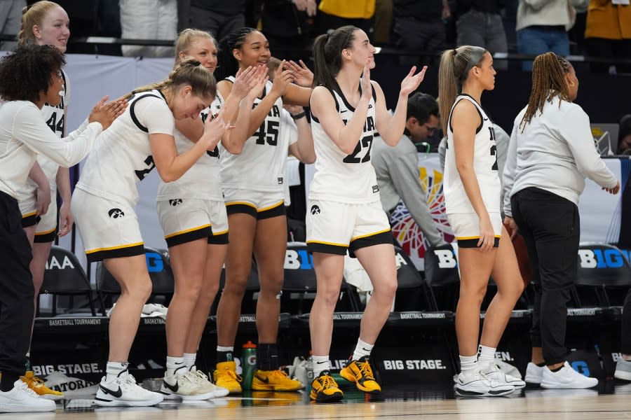 Iowa guard Caitlin Clark, center, celebrates with teammates as time expires in the team’s win over Michigan following an NCAA college basketball game in the semifinals of the Big Ten women’s tournament Saturday, March 9, 2024, in Minneapolis. (AP Photo/Abbie Parr)