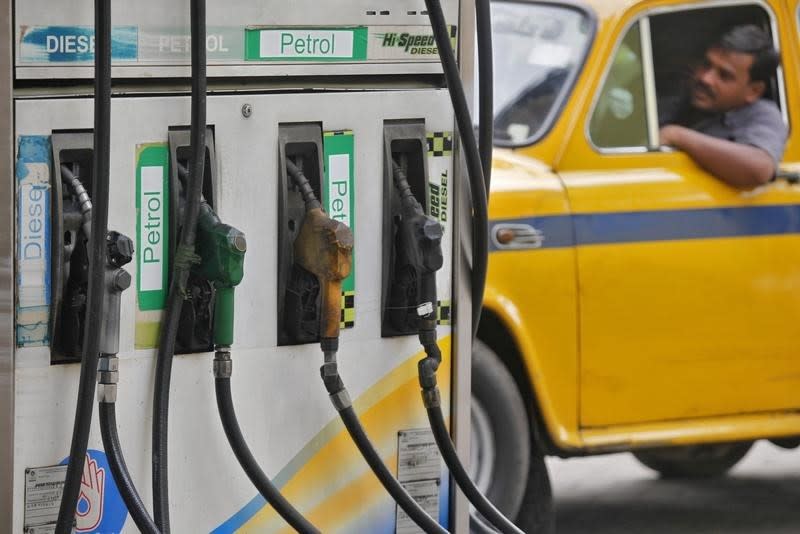 A driver waits in a taxi for his turn to fill up his tank with diesel at a fuel station in Kolkata June 14, 2012. REUTERS/Rupak De Chowdhuri/Files