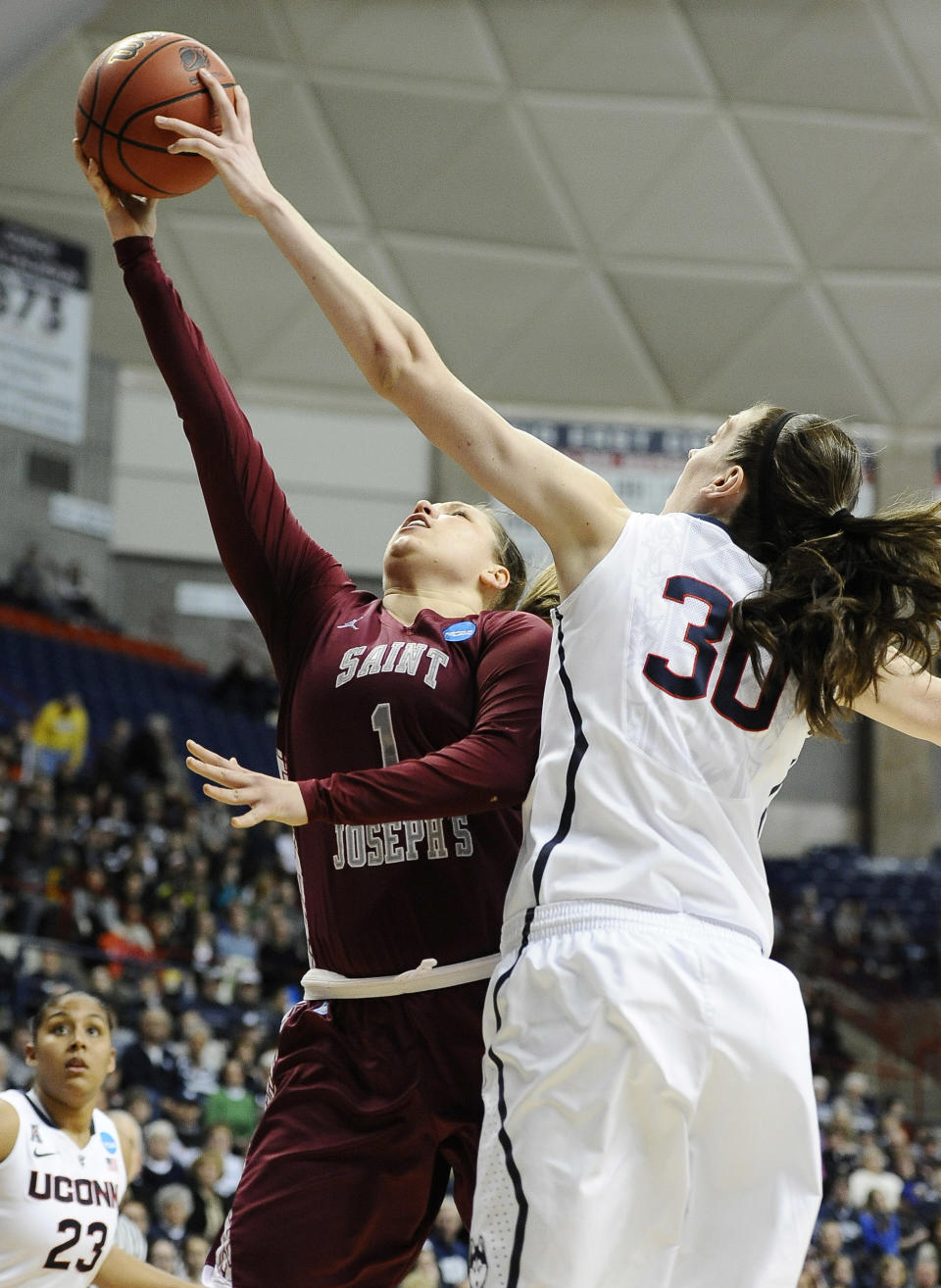 Connecticut's Breanna Stewart, right, blocks a shot attempt by Saint Joseph's Ilze Gotfrida, left, during the first half of a second-round game of the NCAA women's college basketball tournament, Tuesday, March 25, 2014, in Storrs, Conn. (AP Photo/Jessica Hill)