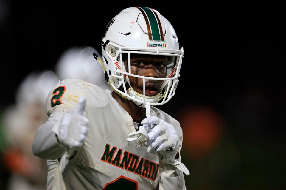 Mandarin wide receiver Jaime Ffrench signals to teammates during a 2022 game against Bolles.