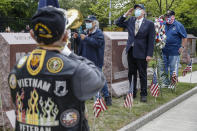 A motorcade of veterans stops outside the Veteran Affairs Medical Center as wreaths are lain beside memorial stones on the premises on Memorial Day, Monday, May 25, 2020, in the Brooklyn borough of New York. (AP Photo/John Minchillo)