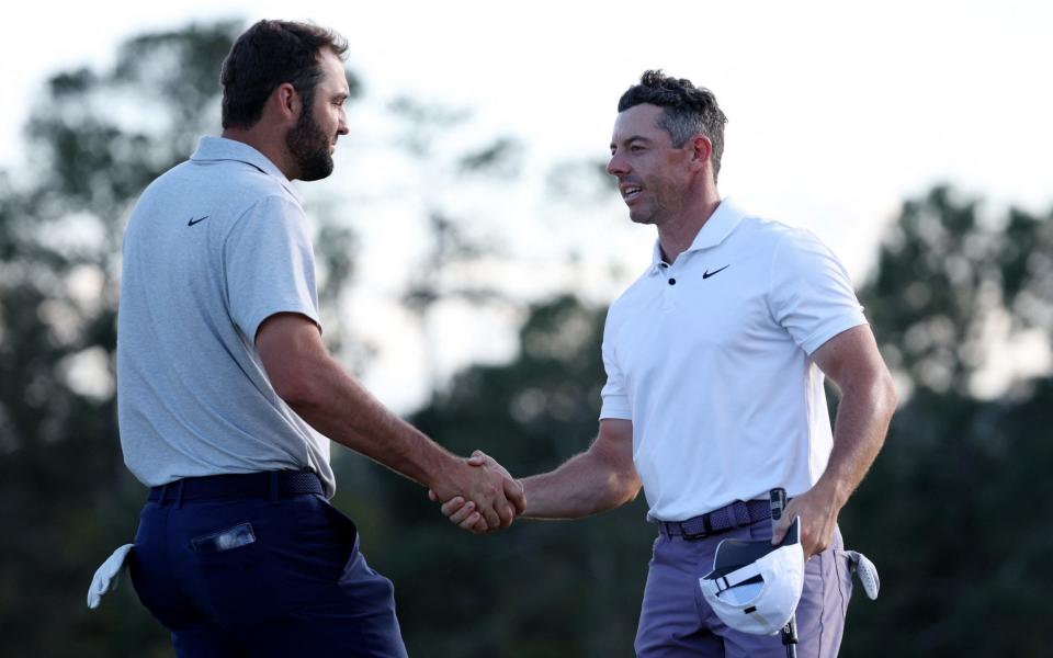 Scottie Scheffler of the U.S. shakes hands with Northern Ireland's Rory McIlroy