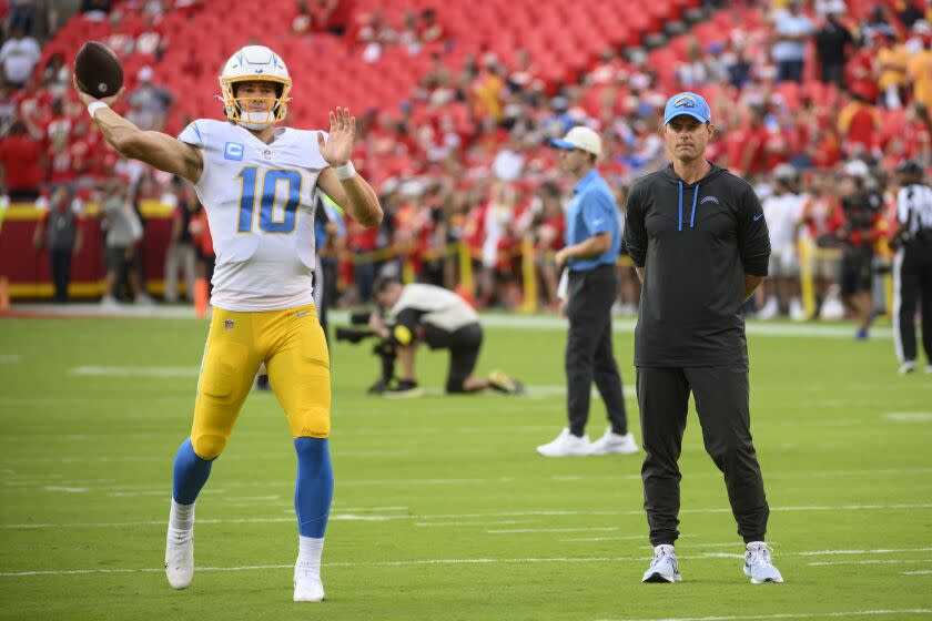 Los Angeles Chargers head coach Brandon Staley, right, watches Chargers quarterback Justin Herbert (10) during pre-game warmups before an NFL football game against the Kansas City Chiefs, Thursday, Sept. 15, 2022 in Kansas City, Mo. (AP Photo/Reed Hoffmann)