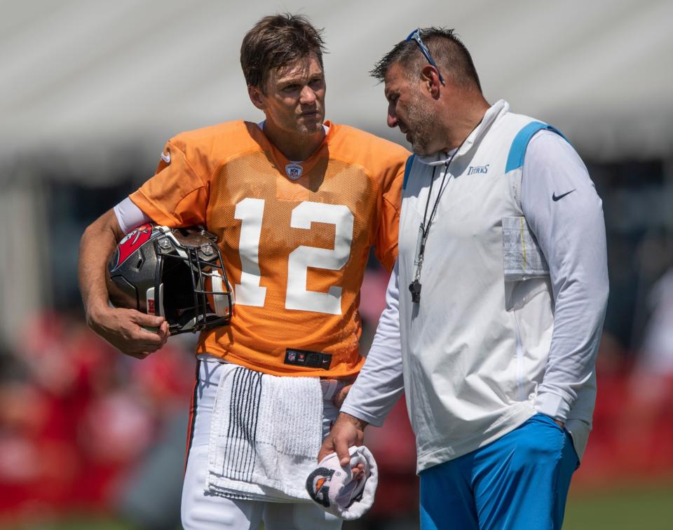 Tampa Bay Buccaneers quarterback Tom Brady (12) talks with Tennessee Titans head coach Mike Vrabel after their joint training camp practice at AdventHealth Training Center Thursday, Aug. 19, 2021 in Tampa, Fla.  