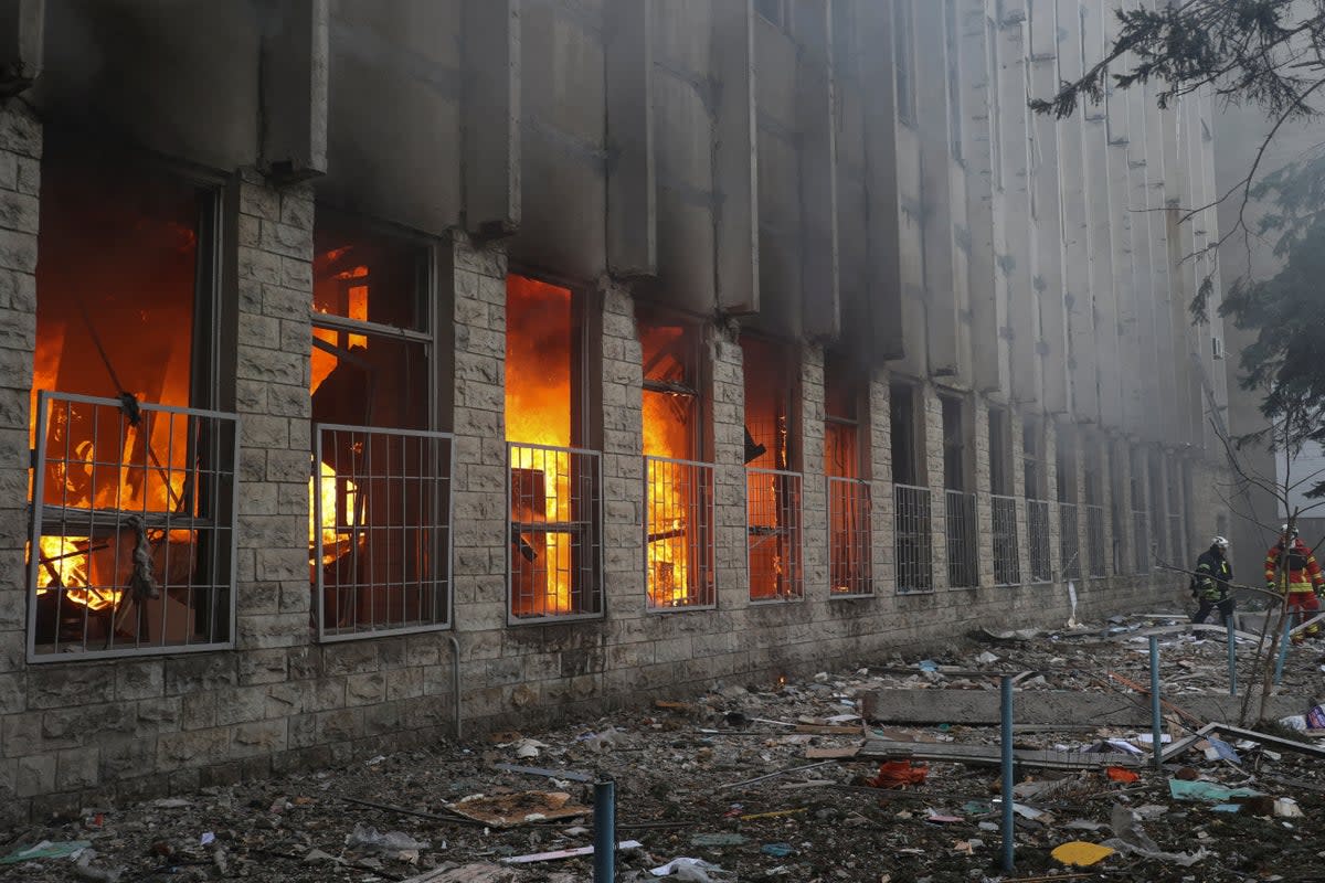 Firefighters at a printing house hit by a Russian missile in Kharkiv (Reuters)