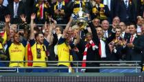 Arsenal manager Arsene Wenger and Nacho Monreal celebrate with the trophy after winning the FA Cup Final as Theo Walcott, Aaron Ramsey and chief executive Ivan Gazidis look on. Reuters / Eddie Keogh