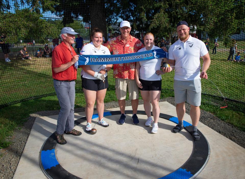 Creswell's Lonn Robertson, left, joins Finnish hammer thrower Silja Kosonen, four-time American Olympian Lance Deal, and Finnish hammer throwers Krista Tervo and Tuomas Seppänen, right, in the ring of the new hammer pit built especially for the Finnish throwers before their arrival for the World Athletic Championship Oregon22.