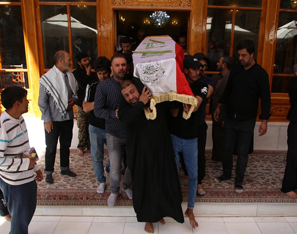 Mourners carry the flag-draped coffin of a protester killed during anti-government protesters during his funeral at the Imam Ali shrine in Najaf, Iraq, Saturday, Oct. 5, 2019. The spontaneous protests which started Tuesday in Baghdad and southern cities were sparked by endemic corruption and lack of jobs. Security responded with a harsh crackdown, leaving more than 70 killed. (AP Photo/Anmar Khalil)