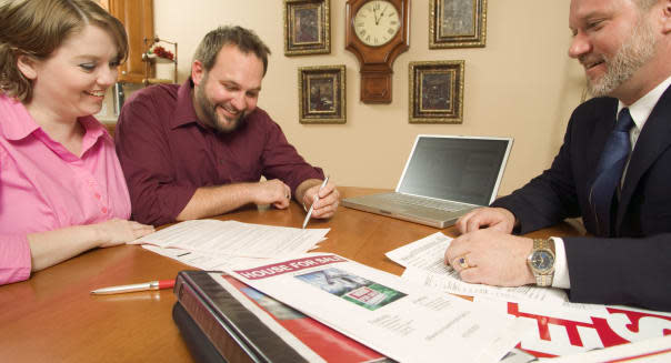 Couple signing contracts