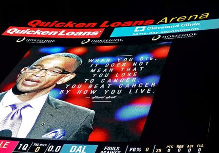 A picture of ESPN broadcaster Stuart Scott is displayed on the scoreboard at Quicken Loans Arena during a moment of silence before the game between the Dallas Mavericks and Cleveland Cavaliers. Mandatory Credit: David Richard-USA TODAY Sports