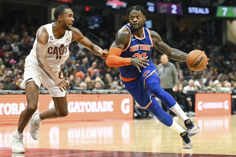New York Knicks forward Julius Randle (30) drives against Cleveland Cavaliers forward Evan Mobley (4) during the second half of an NBA basketball game, Sunday, Oct. 30, 2022, in Cleveland. (AP Photo/Nick Cammett)