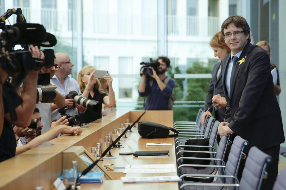 Former Catalan leader Carles Puigdemont, right, arrives for a news conference in Berlin, Germany, Wednesday, July 25, 2018. (AP Photo/Markus Schreiber)