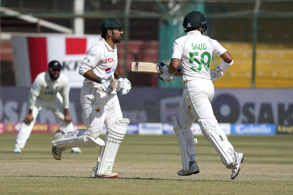 Pakistan's Sarfraz Ahmed, center, and Saud Shakeel, right, take a run during the fifth day of the second test cricket match between Pakistan and New Zealand, in Karachi, Pakistan, Friday, Jan. 6, 2023. (AP Photo/Fareed Khan)