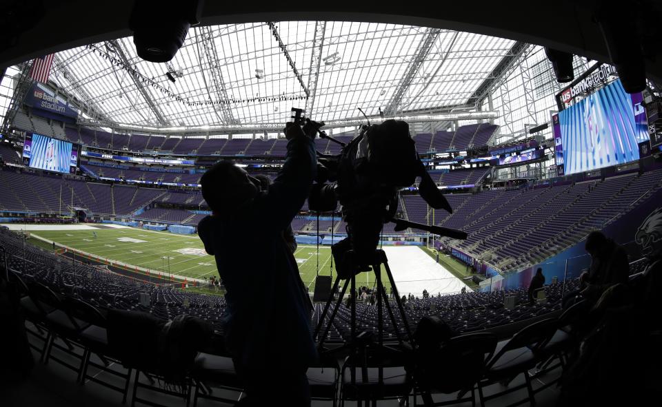 A videographer shoots video of U.S. Bank Stadium as workers get it ready for Super Bowl LI on Tuesday, Jan. 30, 2018, in Minneapolis. (AP)