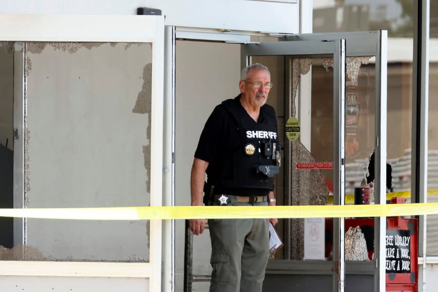 Law enforcement officers work the scene of a shooting at the Mad Butcher grocery store in Fordyce, Ark., Friday, June 21, 2024. (Colin Murphey/Arkansas Democrat-Gazette via AP)