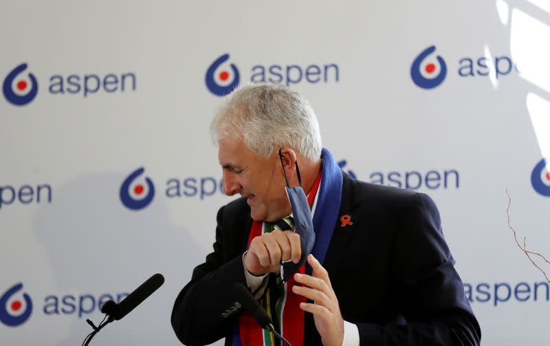 Stephen Saad, CEO of Aspen Pharmacare takes of mask during news conference, in Gqeberha