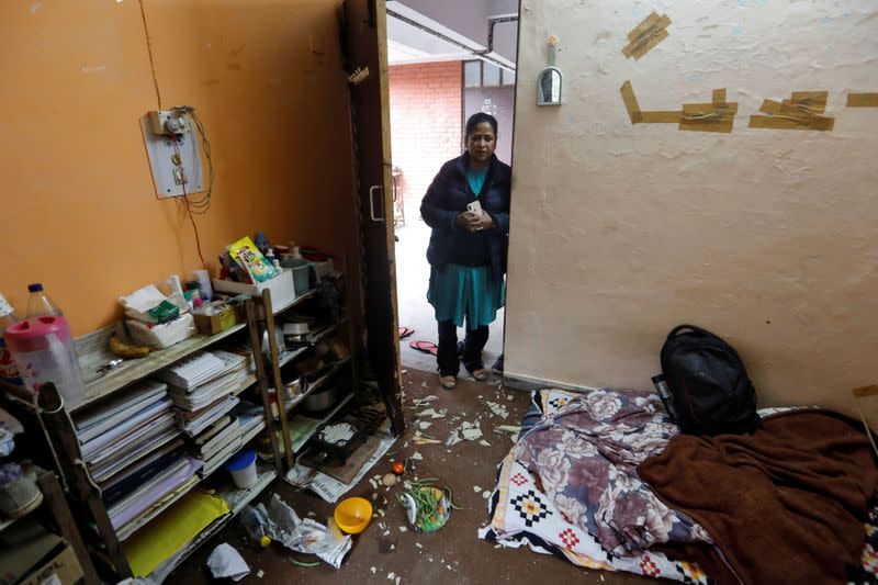 A woman looks at damaged belongings of students of Jawaharlal Nehru University (JNU) at a hostel room after it was attacked by a mob on Sunday, in New Delhi