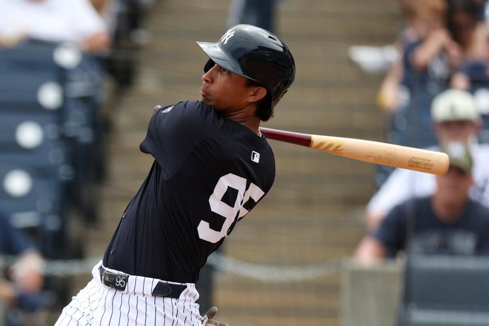 Mar 18, 2024; Tampa, Florida, USA; New York Yankees first baseman Oswaldo Cabrera (95) hits a solo home run against the Philadelphia Phillies in the third inning at George M. Steinbrenner Field. Mandatory Credit: Nathan Ray Seebeck-USA TODAY Sports