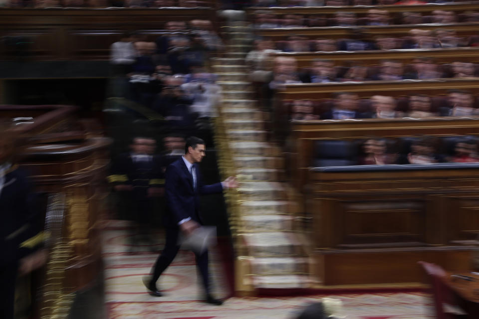 Spain's interim Prime Minister Pedro Sanchez walks to take his seat after addressing the Spanish Parliament in Madrid, Spain, Sunday, Jan. 5, 2020. Sanchez is facing the first of two opportunities Sunday to win the endorsement of the Spanish Parliament to form a left-wing coalition government. It would be Spain's first coalition government since the return of democracy following the death of dictator Francisco Franco in 1975. (AP Photo/Manu Fernandez)