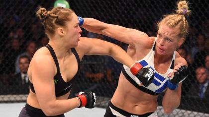 Holly Holm lands a punch on Ronda Rousey during their 2015 fight. (Getty)